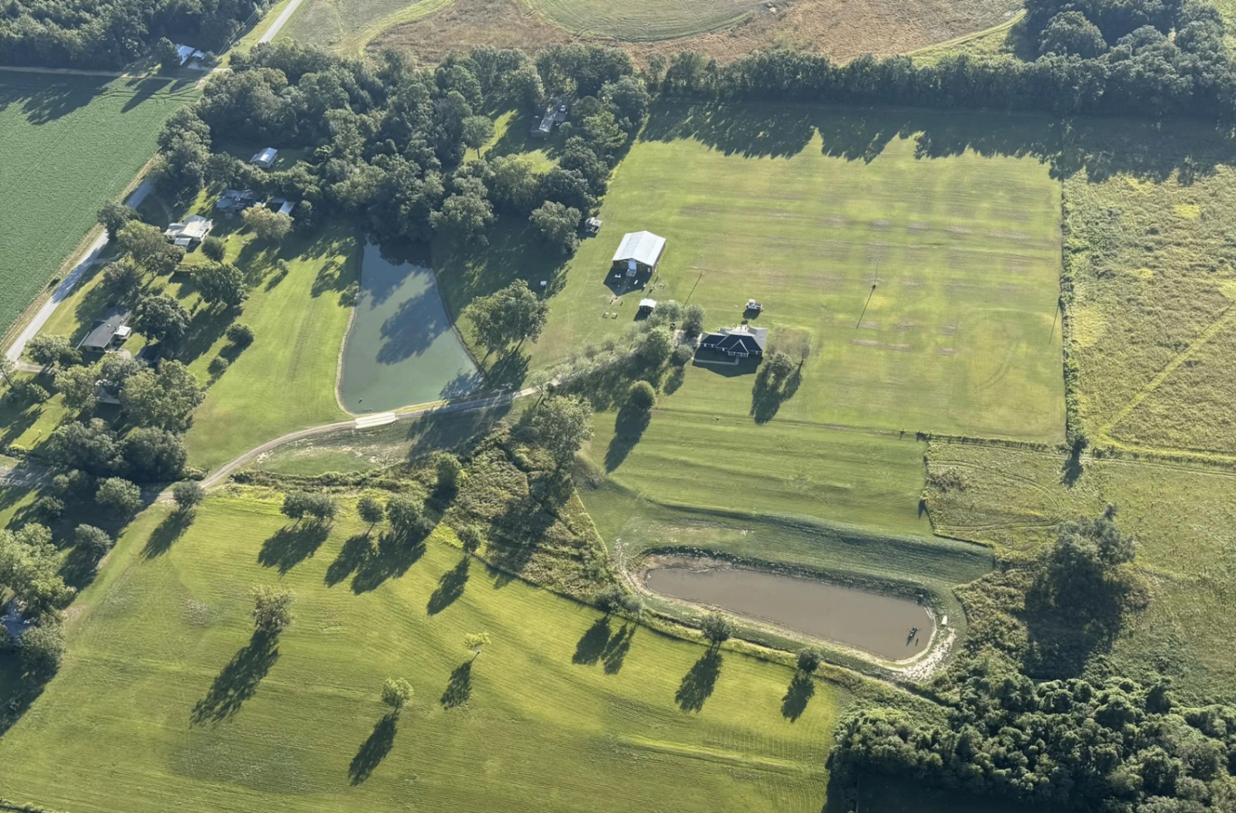 Aerial view of The Loxley Barn property with the barn and two ponds